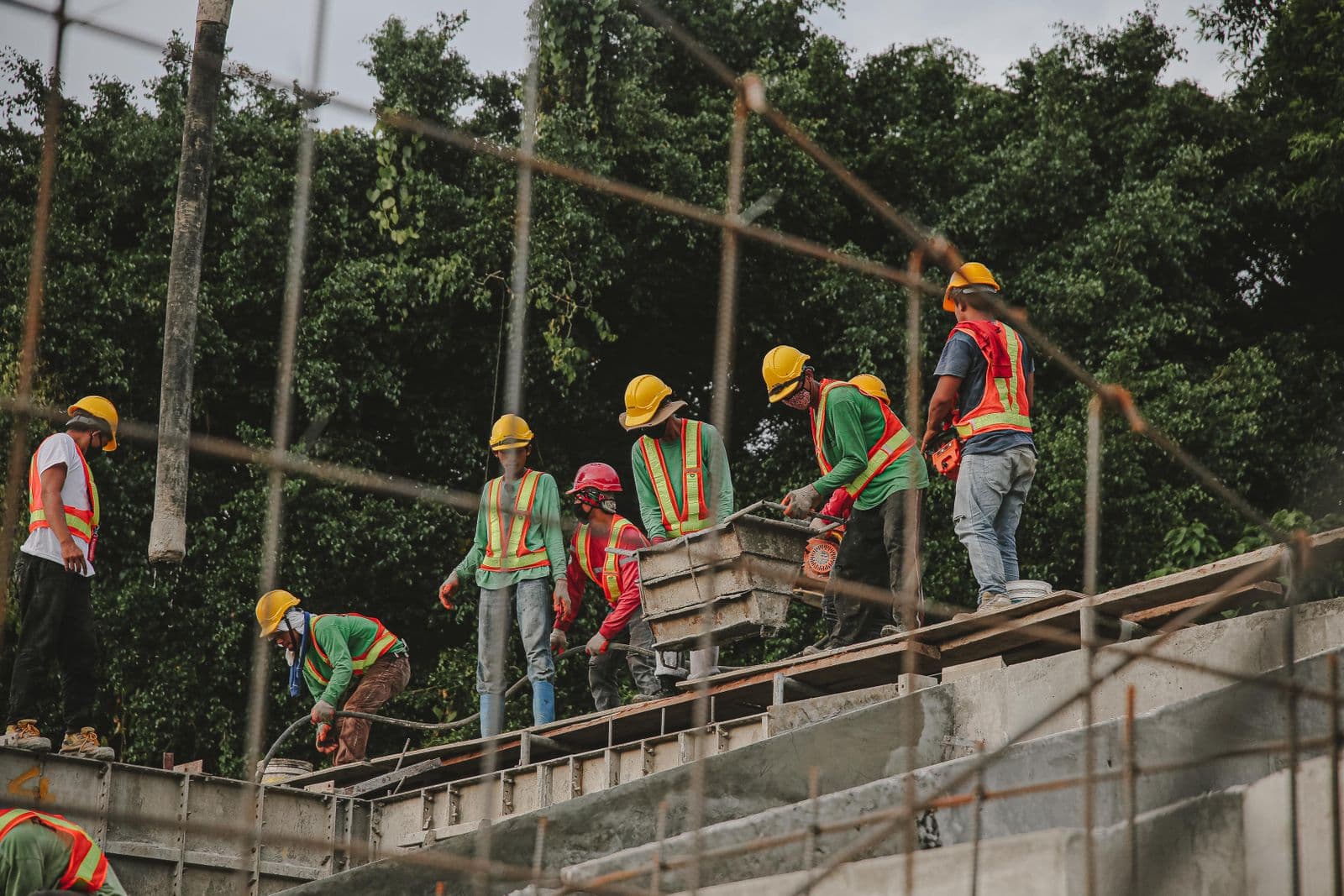 Crew pouring concrete on site